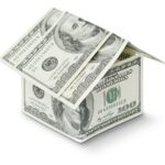 a house made out of money on a white background