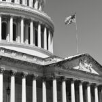 American flag flying above the u.s. capitol building
