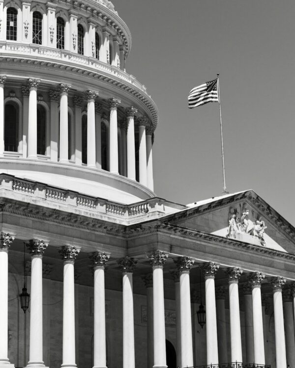 American flag flying above the u.s. capitol building