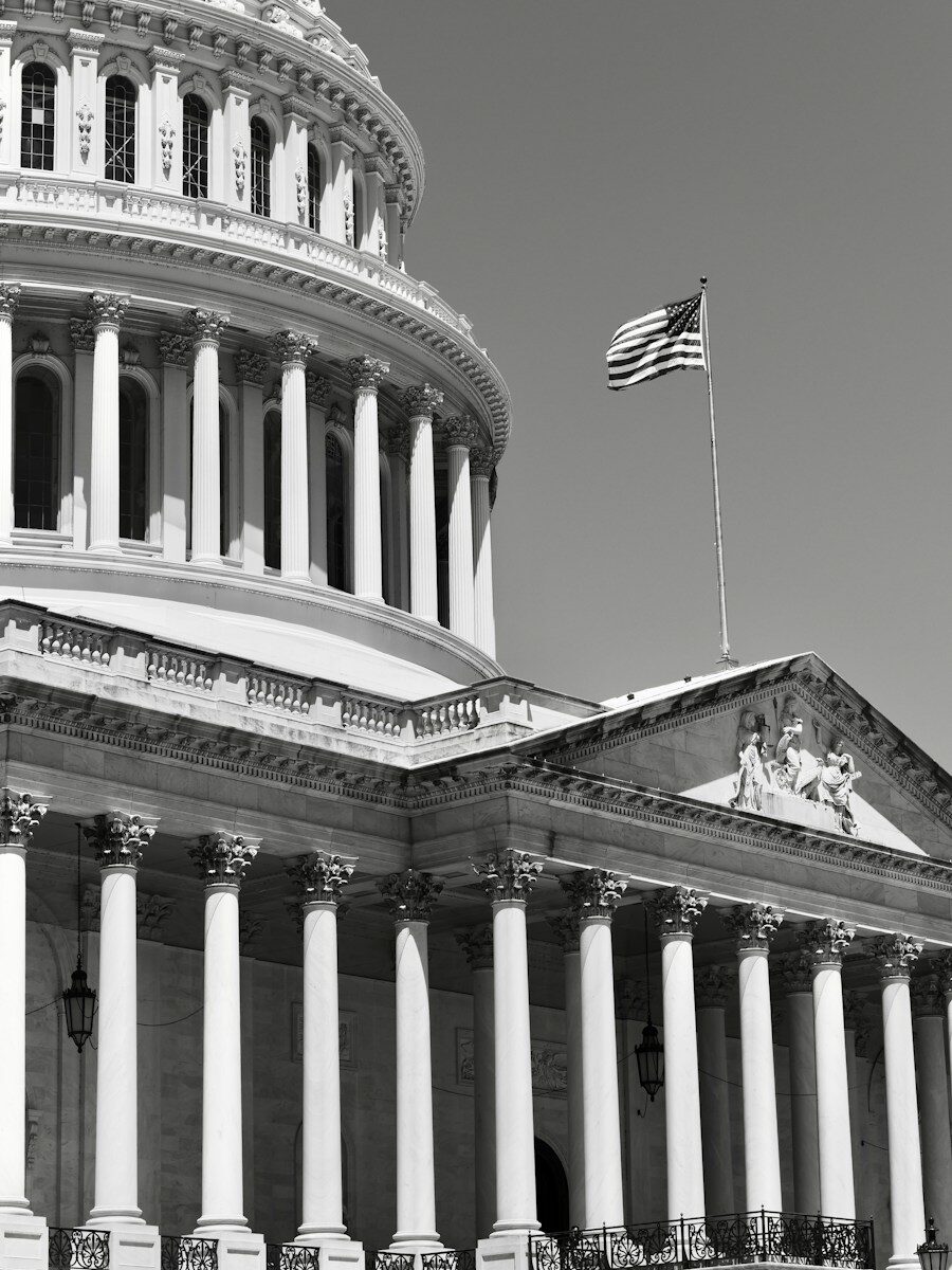 American flag flying above the u.s. capitol building
